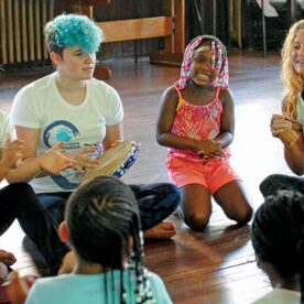 Teaching Artist Leight Robertson with Students Learning About Capoiera