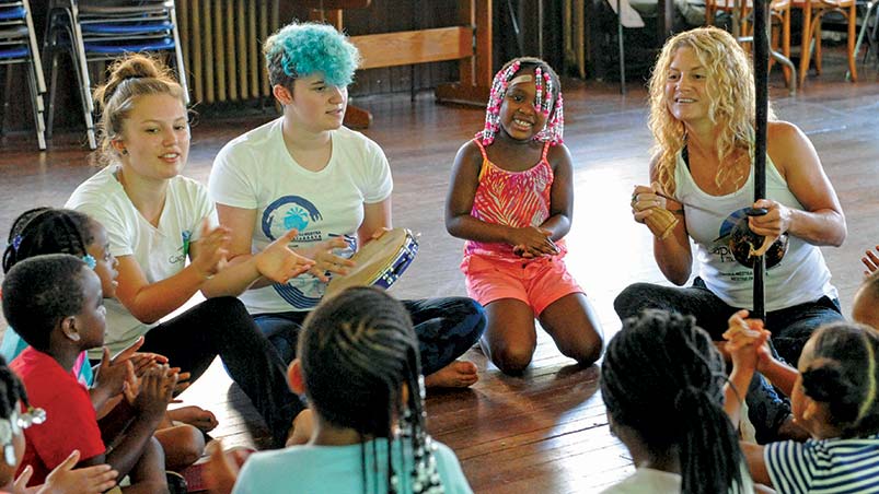 Teaching Artist Leight Robertson with Students Learning About Capoiera