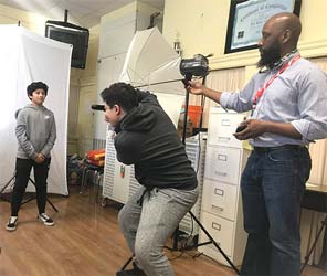 Image of Erik James Montgomery working with students in a photography class