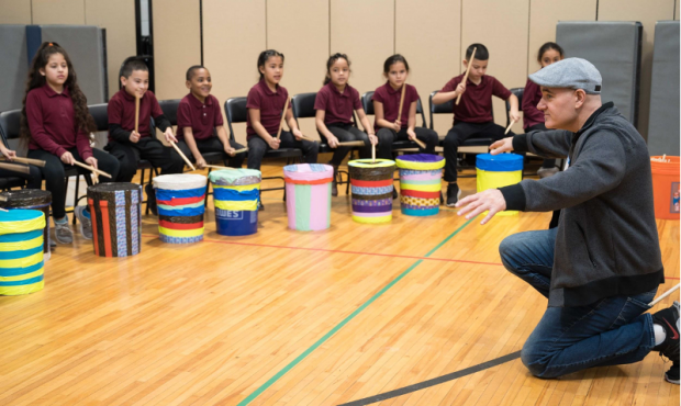 Caption: Teaching artist Josh Robinson leads a warm-up for the students of Washington Avenue Elementary School. Photography by Driven by Design Creative Agency, LLC.