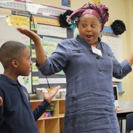 Queen Nur, YA Artist from United We Create Program, with Student teaching Muslim culture